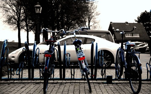 Image white and black bicycle on black metal fence