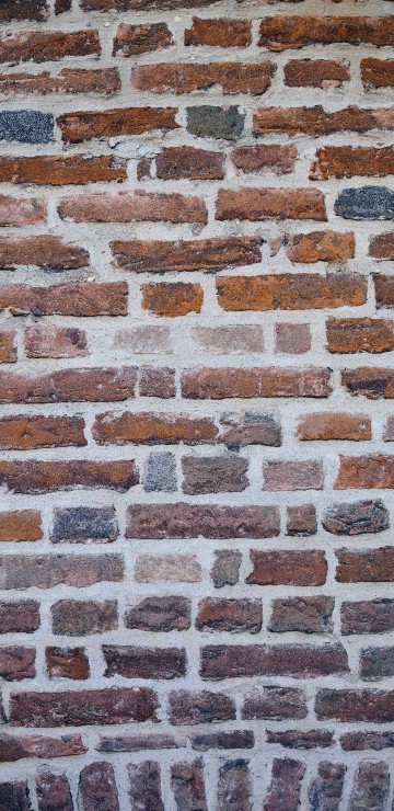 Image brown and black brick wall