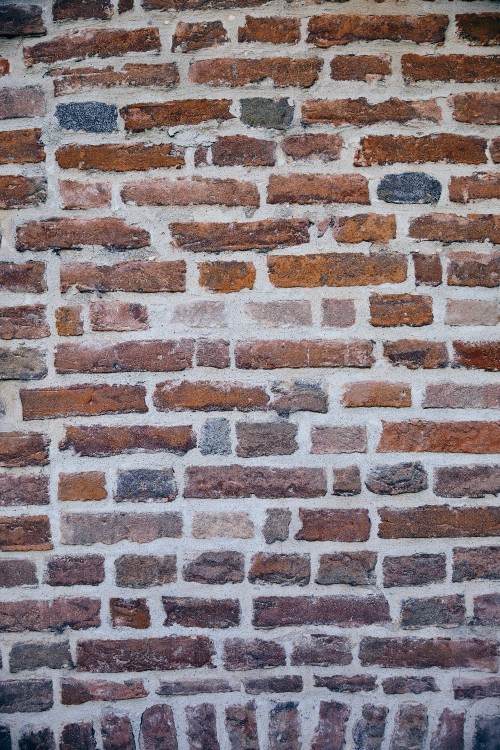 Image brown and black brick wall