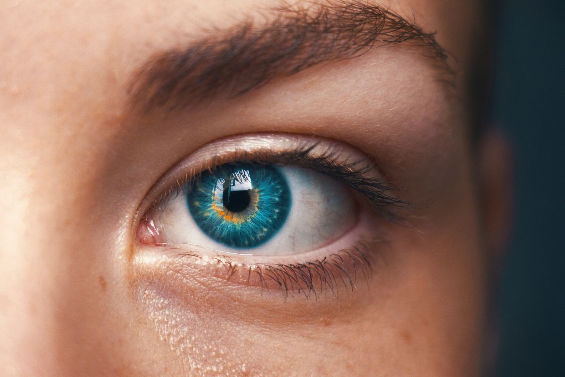 persons blue eyes in close up photography