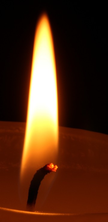Image lighted candle in dark room