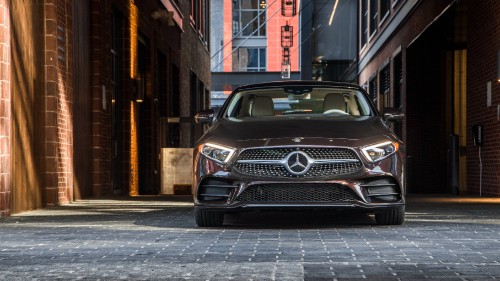 Image black mercedes benz car parked beside brown building during daytime