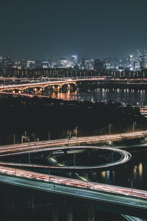 Image white and black bridge over river during night time