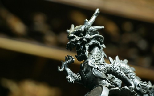 Image silver dragon figurine in tilt shift lens