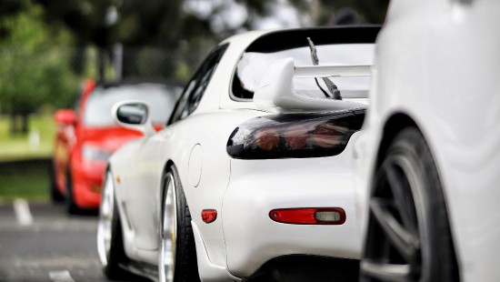 Image white porsche 911 parked on road during daytime