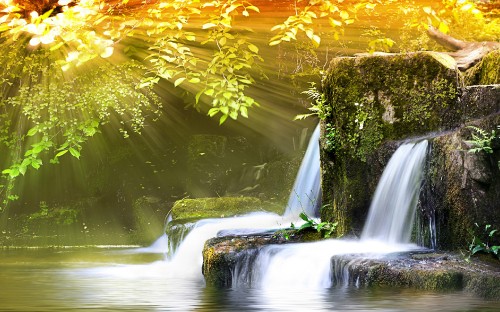 Image water falls in the middle of green moss covered rocks