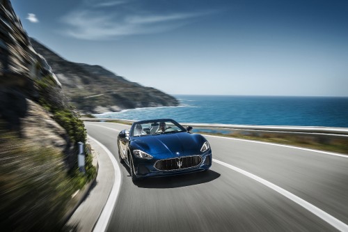 Image blue porsche 911 on road near sea during daytime