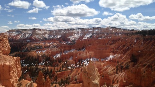 Image brown rocky mountain under blue sky and white clouds during daytime