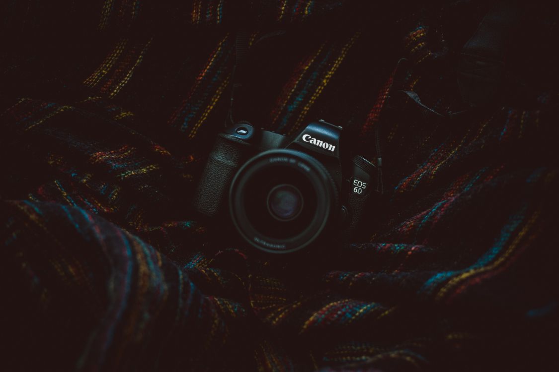 Black Nikon Dslr Camera on Black and Brown Textile. Wallpaper in 5472x3648 Resolution