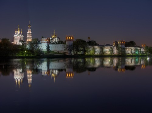 Image body of water near city buildings during night time