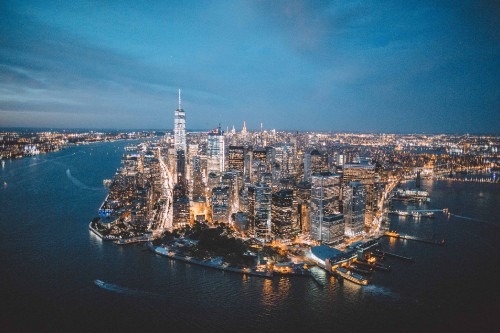 Image city skyline across body of water during daytime