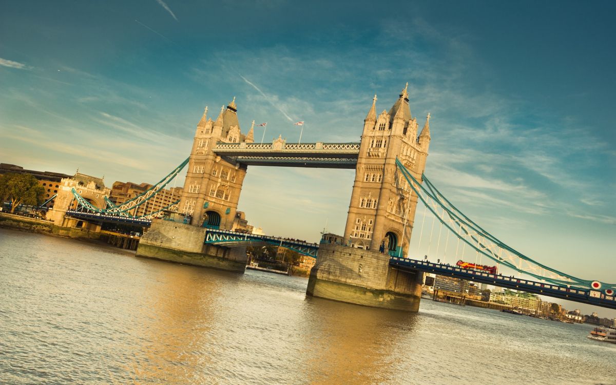 brown concrete bridge under blue sky during daytime