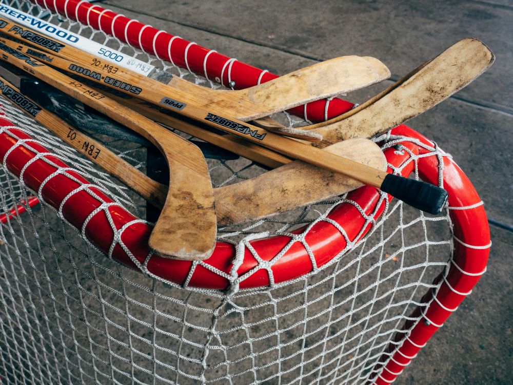 brown wooden boat paddle on net