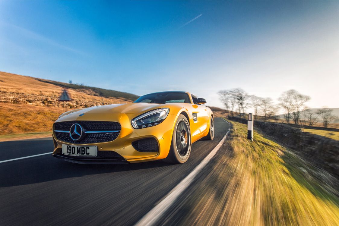 yellow mercedes benz coupe on road during daytime