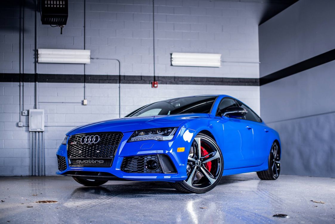 blue audi r 8 parked in garage