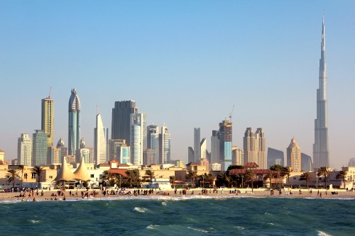 Image city skyline across body of water during daytime