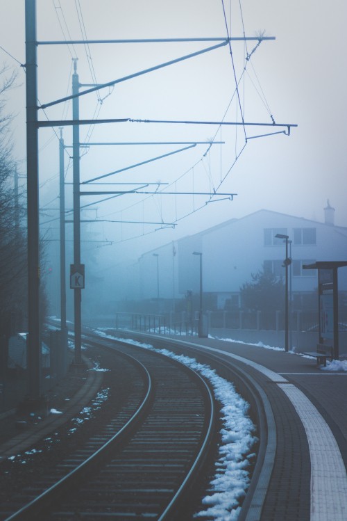 Image black metal train rail during daytime