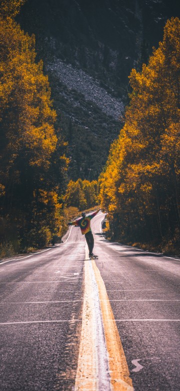 Image man in black jacket riding bicycle on gray asphalt road during daytime