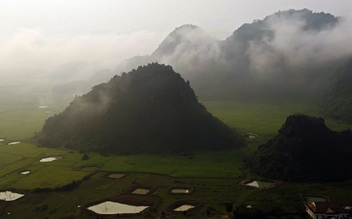 Image green grass field near mountain during daytime