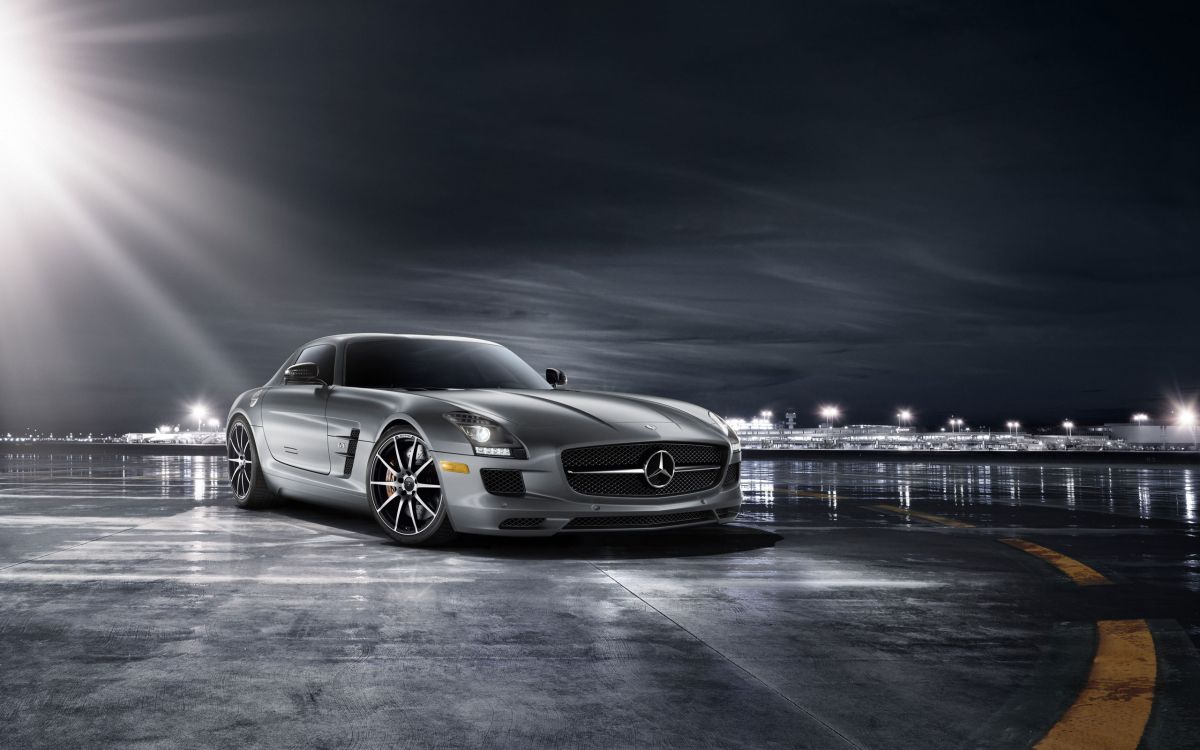 silver mercedes benz coupe on road during night time