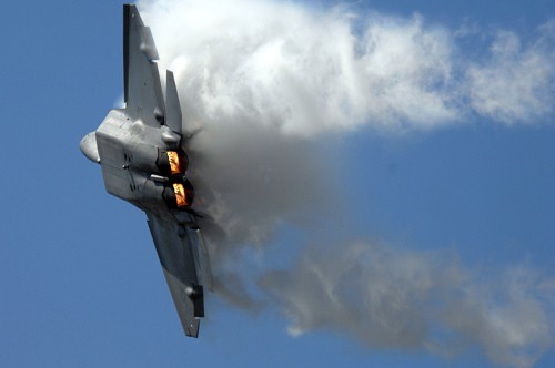 Image black jet plane under white clouds during daytime