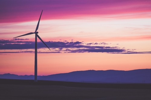 Image wind turbine on hill during sunset