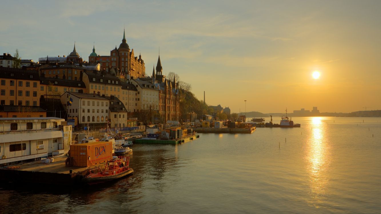 brown boat on river near buildings during daytime