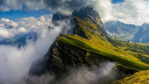 Image green and brown mountain under white clouds