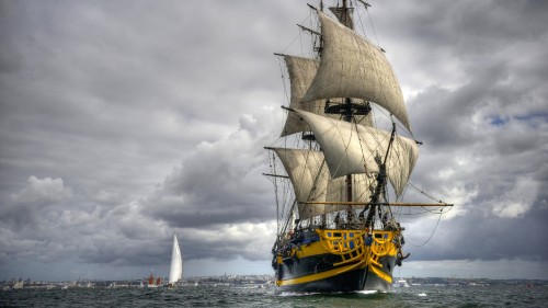 Image brown and white sail ship on sea under white clouds during daytime