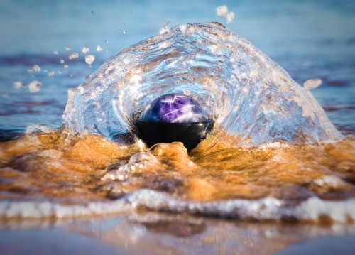 Image purple stone on water during daytime