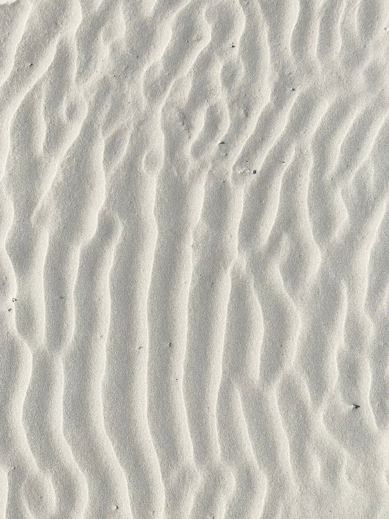 brown sand with footprints during daytime