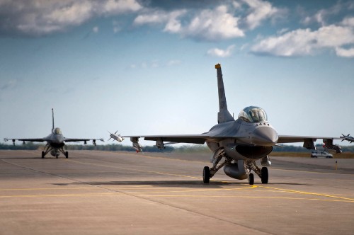 Image gray fighter jet on gray concrete ground under blue and white sunny cloudy sky during daytime