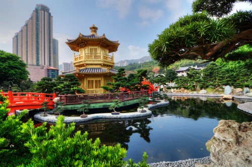 Image brown and beige temple near body of water during daytime