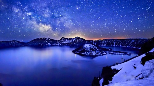 Image body of water near snow covered mountain during night time