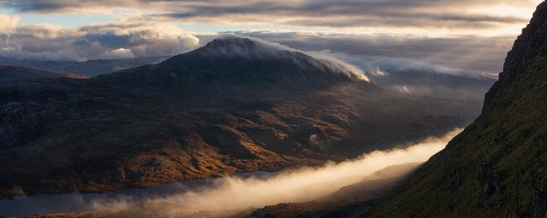 Image brown and green mountains under white clouds during daytime