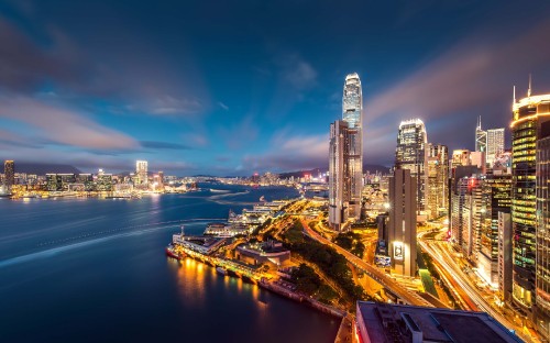 Image city skyline under blue sky during night time