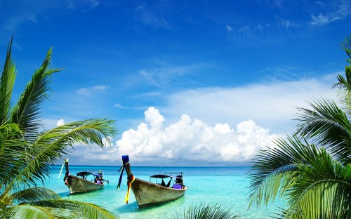 Image man in blue shirt riding on boat on sea under blue and white cloudy sky during