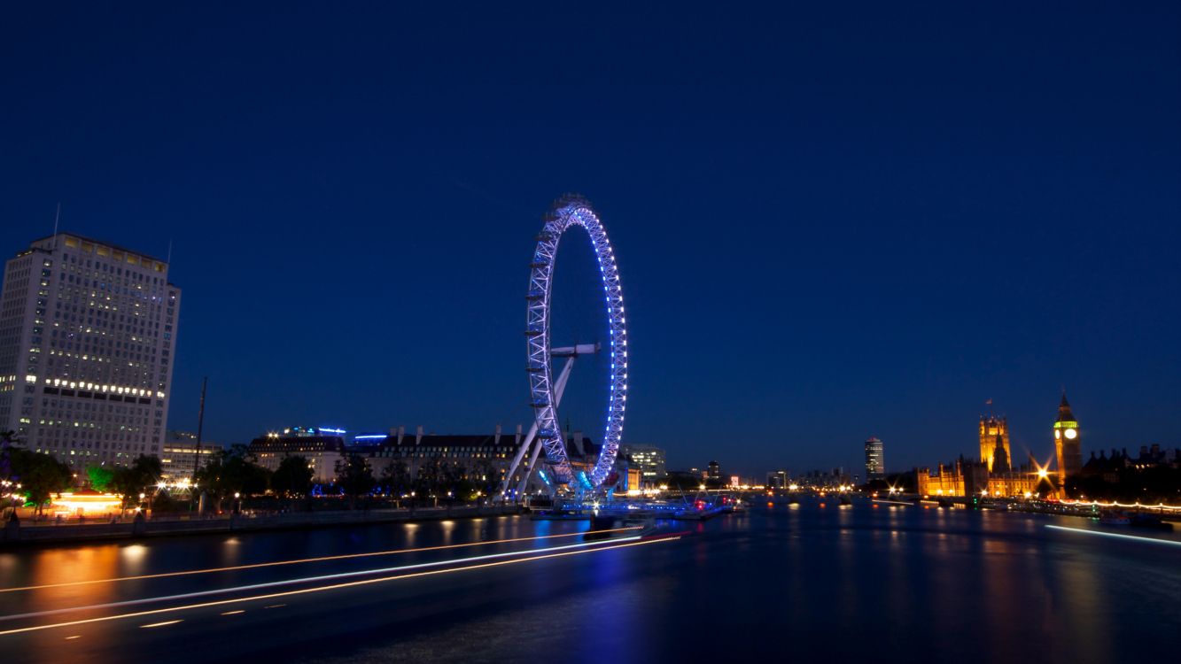 ferris wheel near body of water during night time