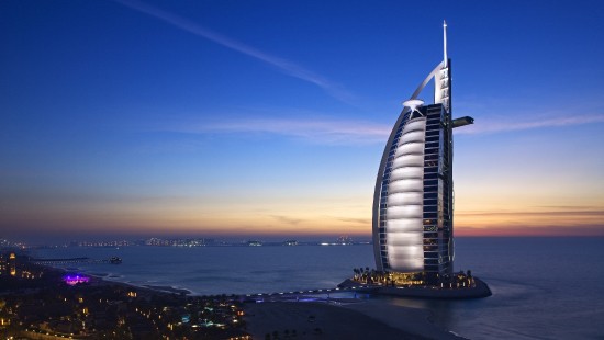 Image white and black building near body of water during night time
