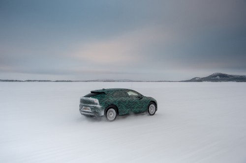 Image green car on snow covered field