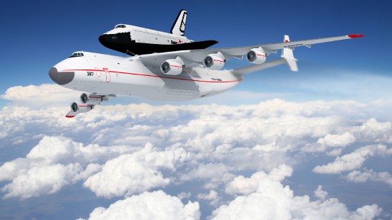 Image white and red airplane under white clouds and blue sky during daytime