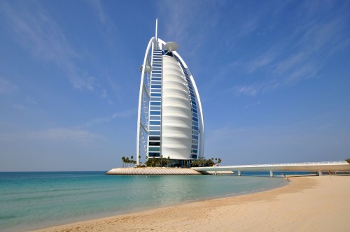 Image white and blue glass building near sea during daytime