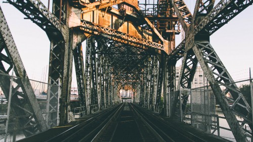 Image black metal train rail during daytime