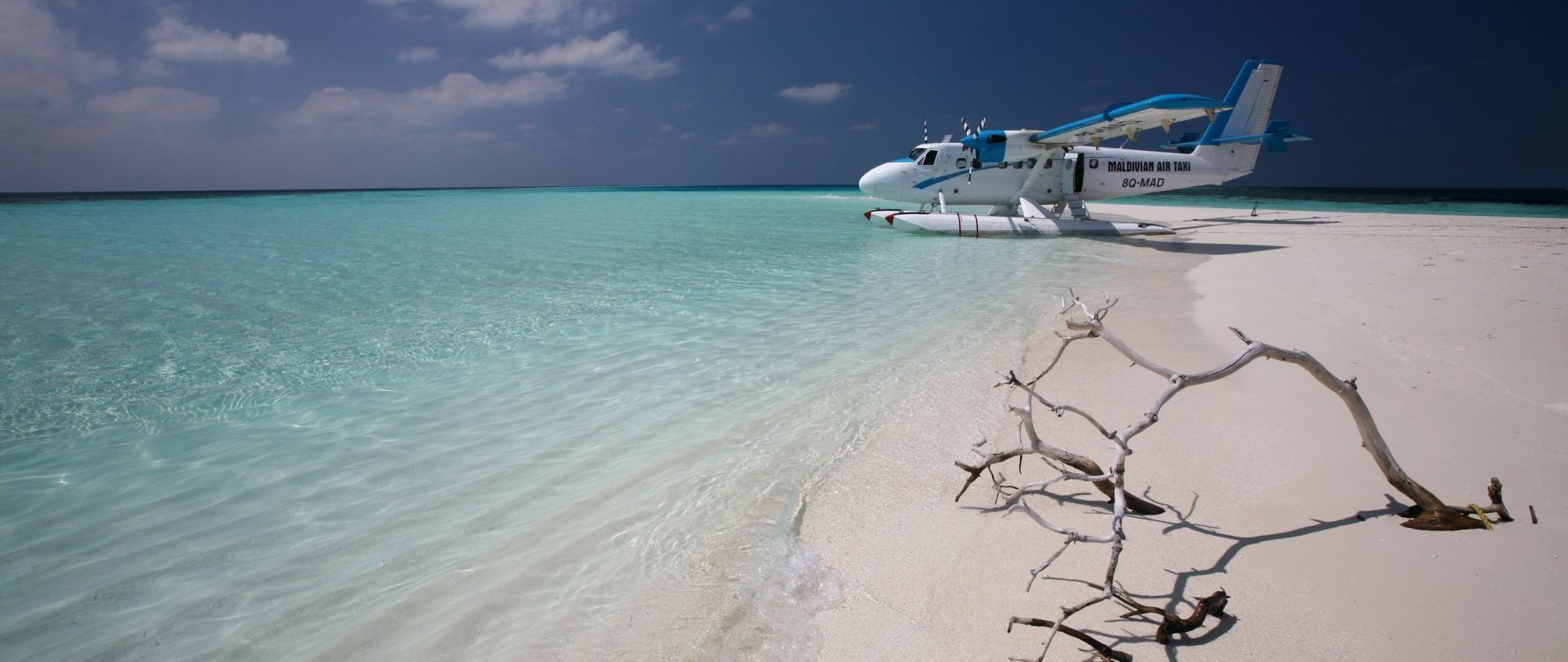 white boat on sea shore during daytime