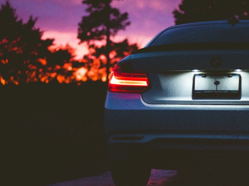 Image black car on road during sunset