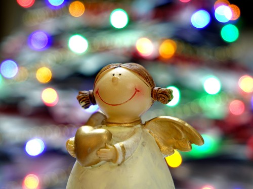 Image white angel ceramic figurine in bokeh photography