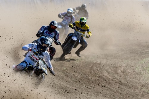 Image man in black and yellow suit riding motocross dirt bike