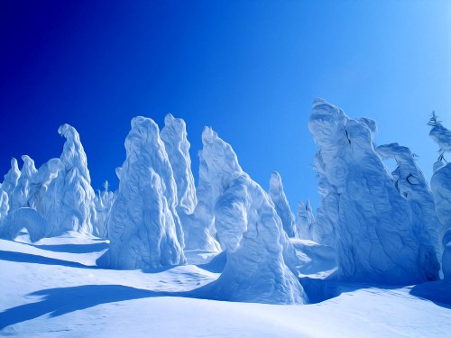 Image white ice formation under blue sky during daytime