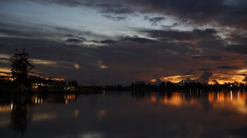 Image body of water near city during sunset