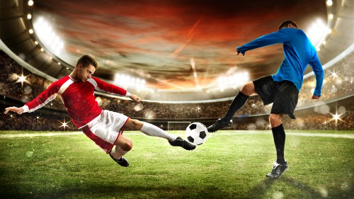 Image boy in red shirt playing soccer on green grass field